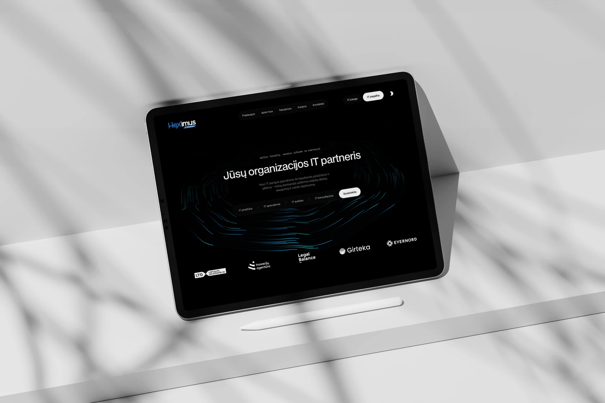 Tablet showing a website design on a desk.